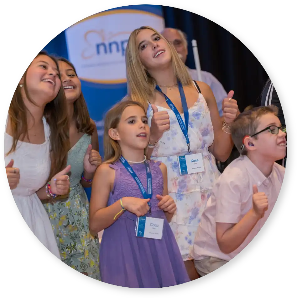 Smiling young people giving a thumbs up at the NNPDF Family Support & Medical Conference