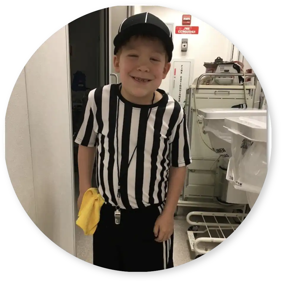 Smiling boy dressed as a referee